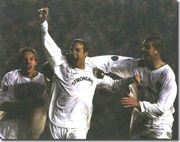 Alan Smith and Dominic Matteo flank Lee Bowyer following the midfielder's winning goal against Milan