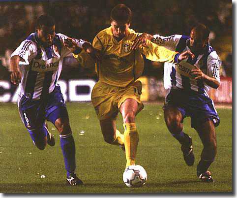 Harry Kewell takes on two Deportivo defenders in Spain