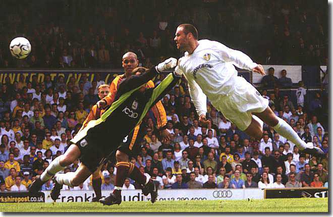 Mark Viduka sails through the air to score in the slaughter of Bradford City