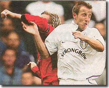 Lee Bowyer turns away after getting elbowed in the face by David Beckham