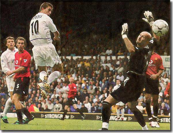 Harry Kewell rises to nod past Manchester United keeper Fabien Barthez with Mark Viduka and Laurent Blanc looking on