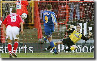 Mark Viduka slots home his hat-trick goal from the spot after Charlton defender Luke Young was adjudged to have brought down Alan Smith