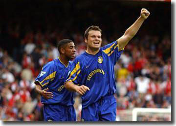 Mark Viduka celebrates scoring the winning goal against Arsenal with Simon Johnson