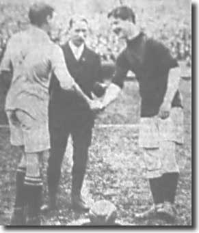Lintott shakes hands with the Glossop captain at the start of the opening match of the season on 6 September 1913