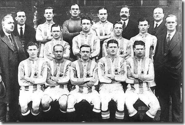 The Huddersfield Town squad 1919/20.  Captain Fred Bullock is third right in the back row, directors N Robinson and F C Mitchell are next to him.  Chairman W L Hardcastle is extreme left in the middle row.  Forward Jack Swan who joined Leeds United in November 1921 is second right at the front. Ambrose Langley, who took over as Huddersfield manager for a short time after Arthur Fairclough's departure, is extreme right middle row