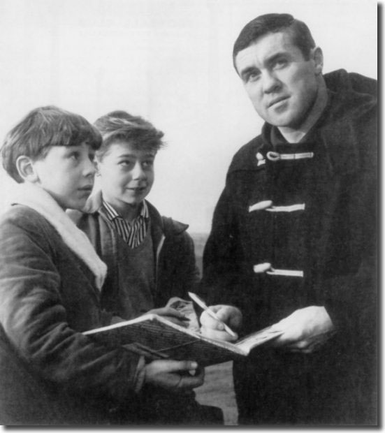 Two starry eyed young fans get Bobby Collins' autograph shortly after he joins Leeds United