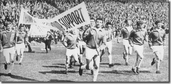 The Leeds players take to the field for a lap of honour before the final home game with Plymouth - Gary Sprake and Paul Reaney carry the banner of thanks - also in shot are Hunter, Collins, Johanneson, Bell, Weston, Charlton, Bremner, Giles