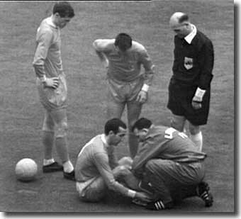 Bob Paisley treats Gerry Byrne after his injury in the Cup final - United never managed to exploit the full-back's discomfort