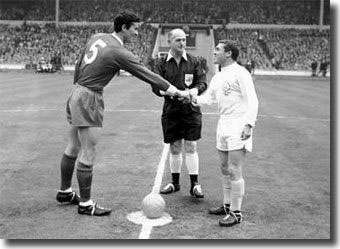 United captain Bobby Collins shakes hands with giant Liverpool skipper Ron Yeats, watched by referee W Clements before the 1965 Cup Final