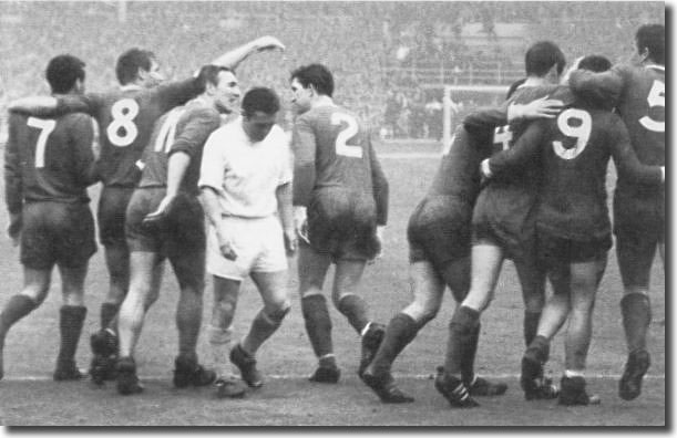 Bobby Collins trudges away in despair after the 1965 Cup final with the victorious Liverpool players celebrating behind him