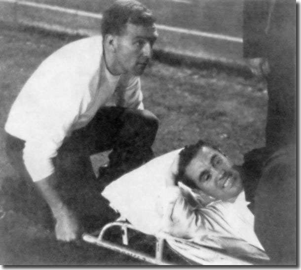 Les Cocker supervises as Bobby Collins is stretchered off in Turin