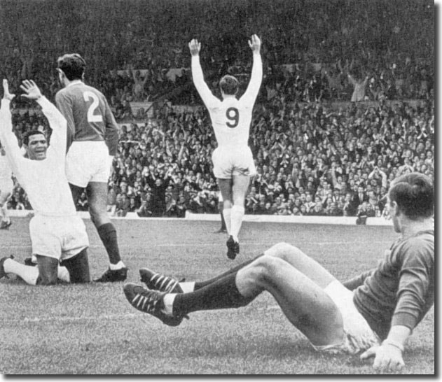 Albert Johanneson acknowledges a bullet header by No 9 Paul Madeley to open the scoring against Manchester United in August