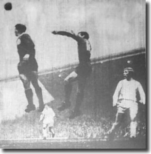 Jimmy Greenhoff is helpless against the aerial dominance of Willie Stevenson and Geoff Strong as Liverpool thrash Leeds 5-0 on November 19 1966