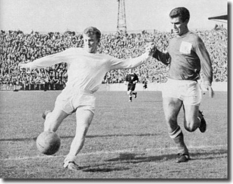 Billy Bremner gets in his shot at the City ground despite the attentions of Forest's Henry Newton - the Scot was later sent off