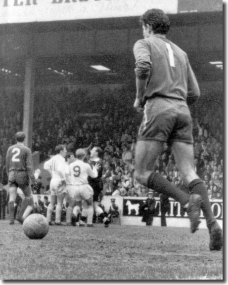 Chelsea keeper Peter Bonetti retrieves the ball after referee Ken Burns disallows Peter Lorimer's goal in the FA Cup semi final - United players mob Burns in protest