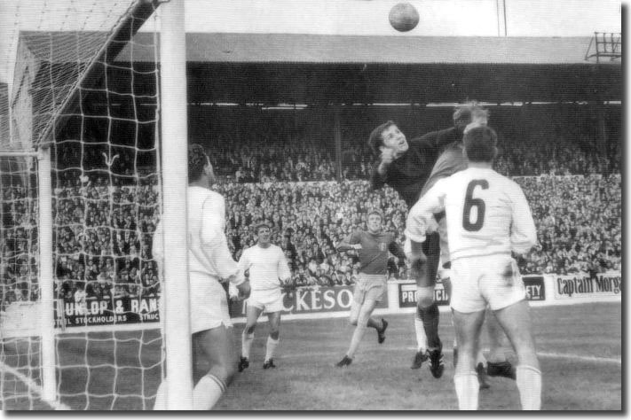 Ferencvaros keeper Geczi struggles to clear a corner under the challenge of Jack Charlton - the ball fell to Mick Jones who gave United the lead