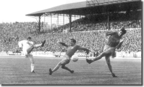 Ferencvaros forward Szoke gets in his shot at Elland Road despite the best efforts of Madeley and Hunter