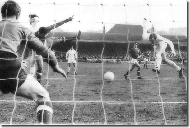 Mick Jones gets in a header at Forest goalkeeper Peter Grummitt during the Elland Road clash in February