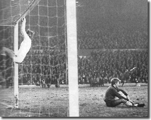 Fazekas hangs onto the United bar in celebration after Dunai's goal for Ujpest during the first leg of the Fairs Cup quarter final at Elland Road