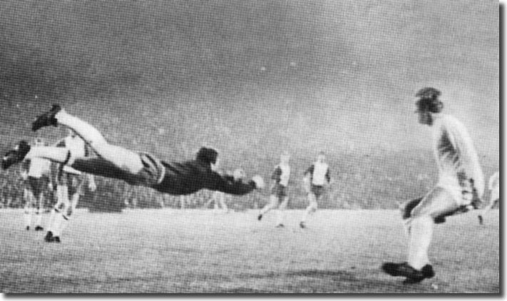 Mick Jones is on hand as Lyn keeper Svein Olsen fists the ball clear