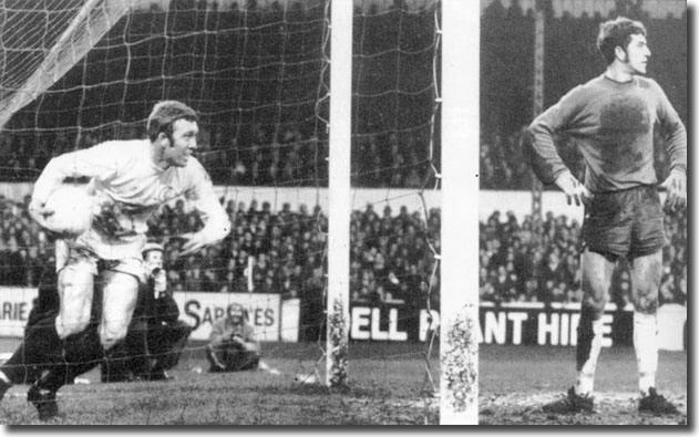 Mick Jones recovers the ball after scoring United's fifth past a disgusted Tommy Hughes