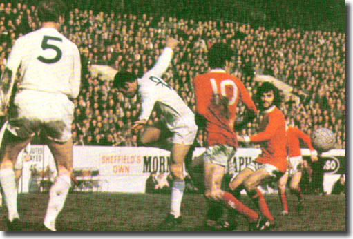 Jack Charlton looks on as Paul Reaney defends against Brian Kidd and George Best in the Cup semi final at Hillsborough