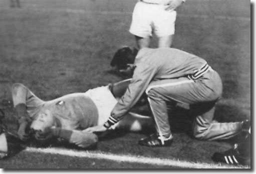 Les Cocker tends to Gary Sprake before the keeper is stretchered off