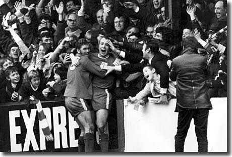 Dave Simmons celebrates with Ray Crawford and the home fans after scoring Colchester's third