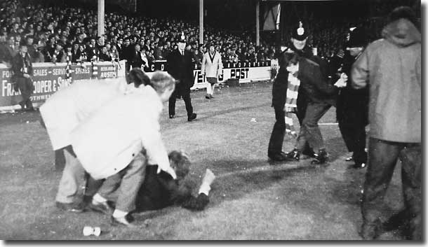 Stewards and police deal with Arsenal fans protesting when Jack Charlton's goal is allowed to stand