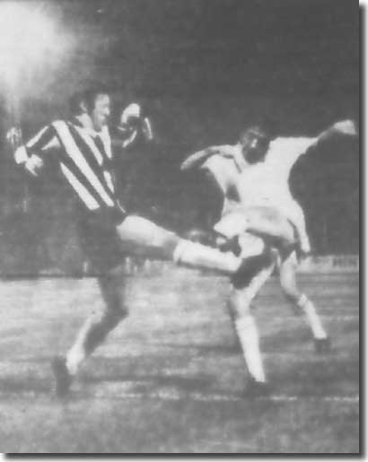 Norman Hunter fires a shot over the bar under pressure from a Lierse defender