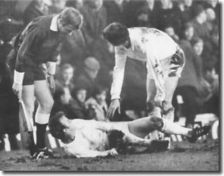Allan Clarke and a linesman look on as Billy Bremner recovers