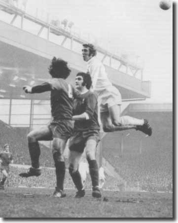 Mick Jones soars above Smith and Lloyd of Liverpool