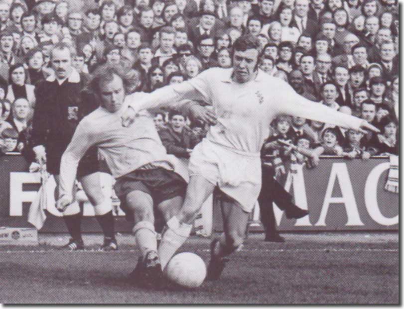 Tottenham's Phil Beal challenges Mick Jones