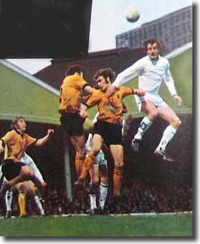 Paul Madeley soars above John McAlle and Frank Munro