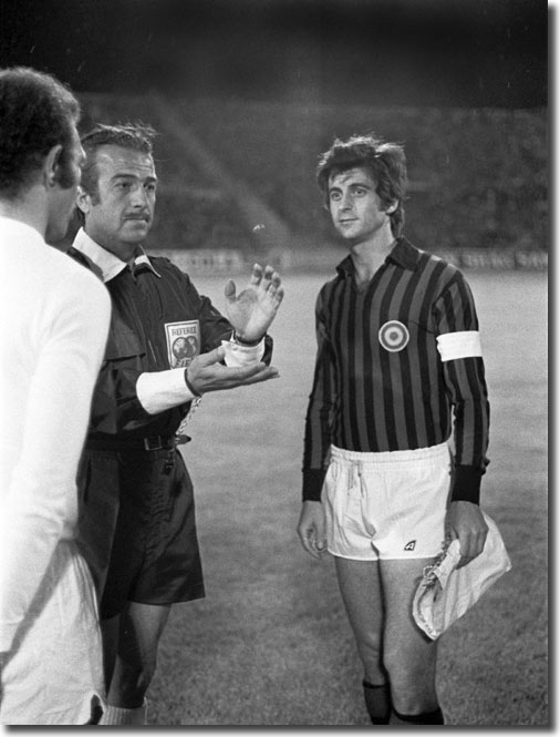 Greek referee Christos Michas tosses the coin at the start of the game with Paul Reaney and Gianni Rivera