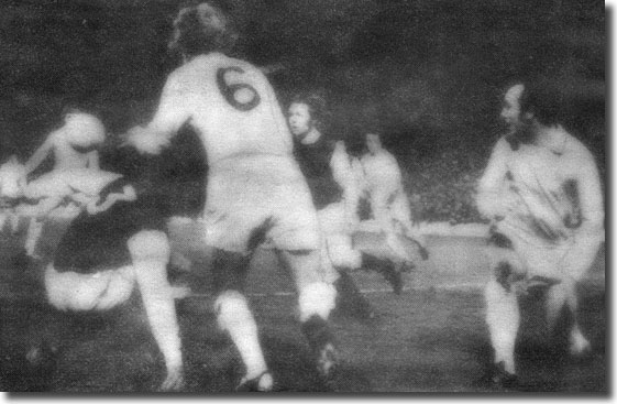 Hibs' Eric Schaedler and Jim Black deny Terry Yorath and Roy Ellam in one Leeds attack