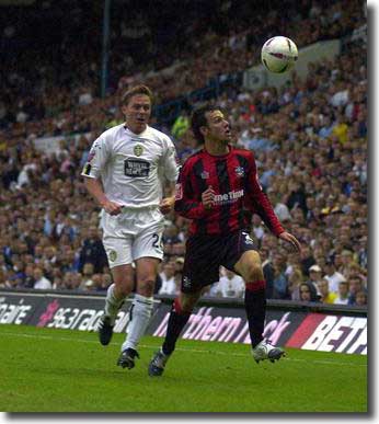 Huddersfield Town's Andy Holdsworth holds off Steve Guppy during the League Cup-tie 24 August 2004