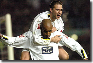 David Healy helps Brian Deane celebrate