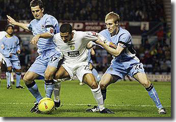 Aaron Lennon holds off the challenge of two Coventry players - the young winger made an outstanding impact after being given his opportunity by Kevin Blackwell