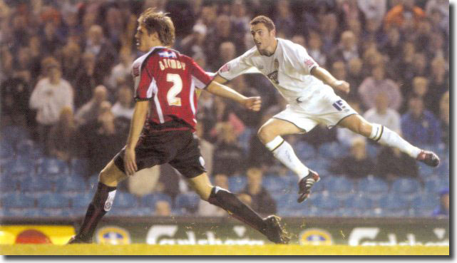 An airborne Frazer Richardson watches his piledriver whizz past Sheffield United defender Leigh Bromby to put the Whites 1-0 up