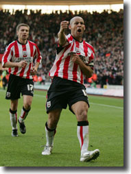 Quashie and Pahars, the Saints scorers, celebrate