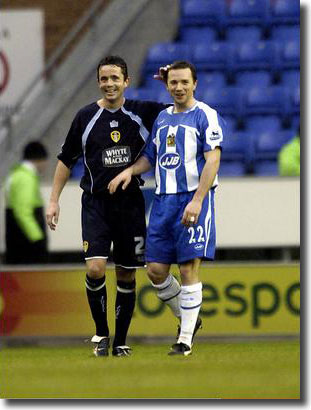 It's all smiles for Gary Kelly and David Connolly of Wigan after the draw at the JJB - Connolly opened the scoring and didn't exactly endear himself to United's travelling support