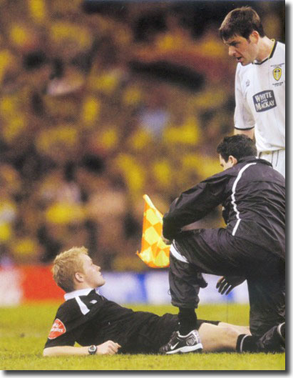 Paul Butler is incredulous as the referee's assistant receives treatment