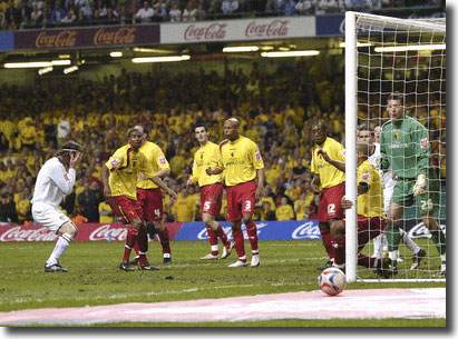 Shaun Derry holds his head as the ball trickles past the post