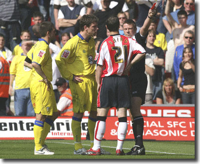 Referee Tony Bates sends off Alan Thompson at Southampton on 21 April with David Healy looking on