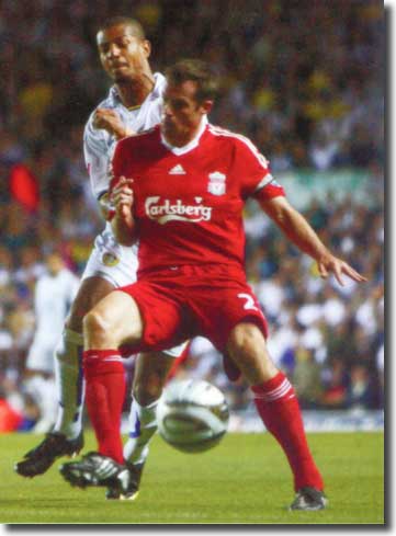Liverpool captain Jamie Carragher holds off Jermaine Beckford
