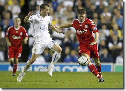 Jonny Howson tangles with Liverpool skipper Steven Gerrard