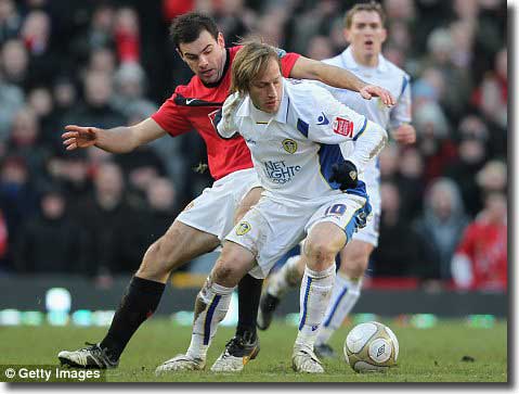 Luciano Becchio holds off the challenge of United’s Darren Gibson