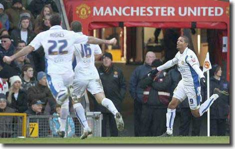 Hughes and Johnson run over to congratulate Beckford after his goal at Old Trafford