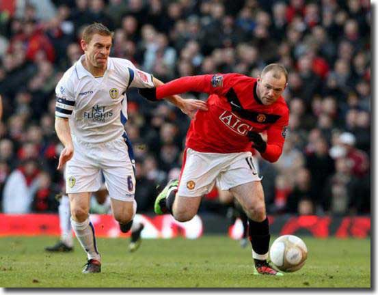 Richard Naylor chases Wayne Rooney during the game